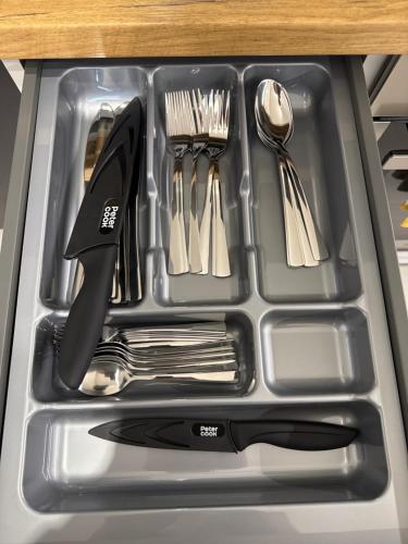 a metal tray with utensils in a sink at APARTAMENT KASZMIR w KRÓLEWSKIM SANDOMIERZU in Sandomierz