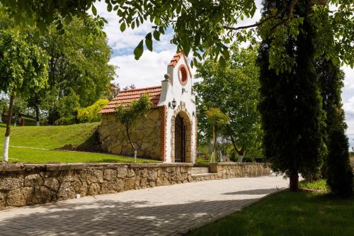 a small stone building with a clock tower at Sobor Family Resort in Stavcheny