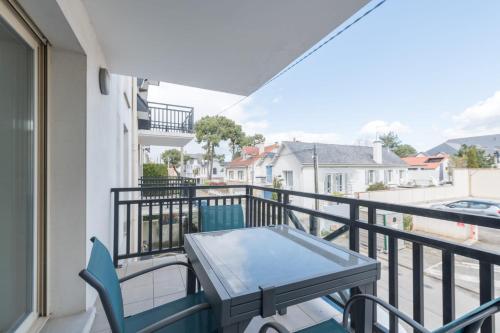 a balcony with a table and chairs on a balcony at Le Colombe - Centre de La Baule - Wifi in La Baule