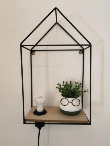 a shelf with a plant and a vase on it at Δροσιά in Nafplio