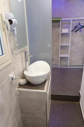 a bathroom with a white sink and a shower at Duomo Suite - A Step from the Cathedral in Monreale