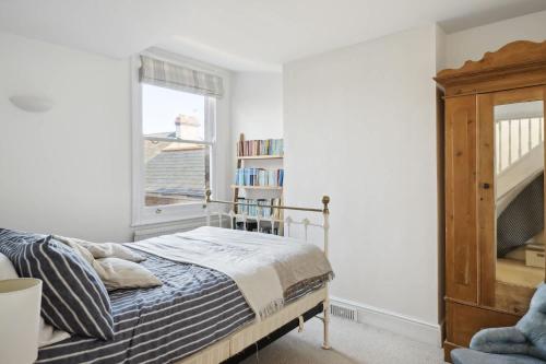 a bedroom with a bed and a window at Beautiful Victorian Home on Peaceful Green Square in Exeter