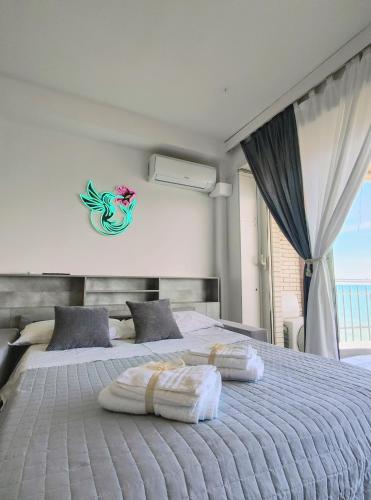 a bedroom with a bed with two pillows on it at Colibrì in Nettuno
