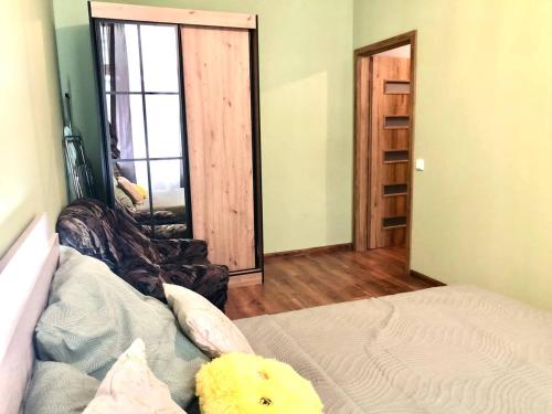 a bedroom with a bed with a teddy bear sitting on it at Oasis Valley in Karlovy Vary