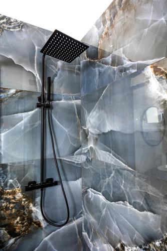 a bathroom with a stone wall with a shower at A due passi in Capri