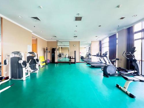 a gym with several treadmills and cardio machines at Holiday Inn Temple Of Heaven Beijing by IHG in Beijing