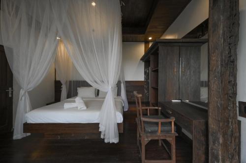 a bedroom with a bed with curtains and a piano at The Lavana Villa Ulin Cemagi in Canggu