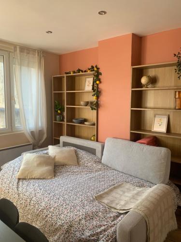 a bedroom with a bed with two pillows on it at Douce Escale en Plein Centre - Avec Parking privé in Boulogne-sur-Mer
