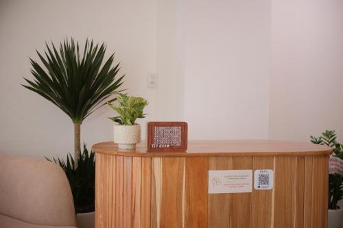 a wooden podium with a plant on top of it at Glory 2 Hue Homestay in Hue