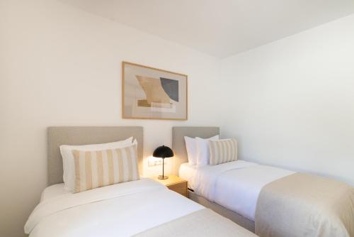 two beds sitting next to each other in a bedroom at Ramada Hotel & Suites by Wyndham Costa del Sol in Fuengirola