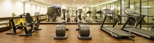 a gym with rows of treadms and cardio machines at Ilunion Hacienda de Mijas in Mijas