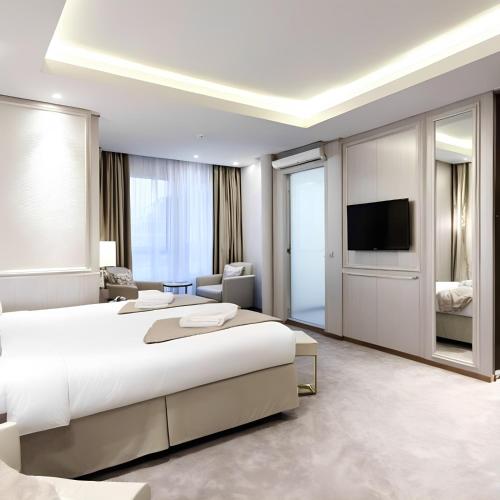 a bedroom with a large bed and a television at simge pansiyon in Istanbul