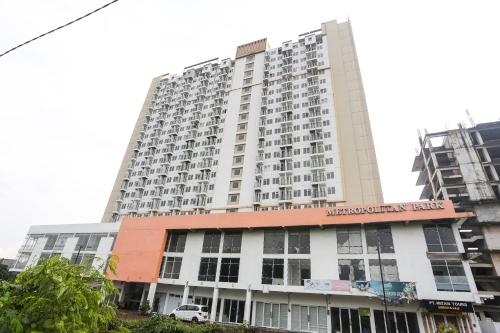 a large white building with a sign on it at Hotel Metropolitan Park 6 Hour Stay in Bekasi