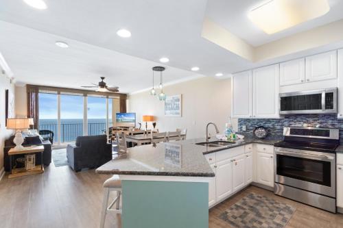 a kitchen and living room with a view of the ocean at San Carlos 1503 in Gulf Shores