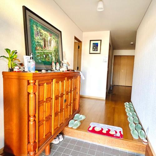 a room with a wooden dresser with a painting on the wall at Makeit 1to3 - Vacation STAY 17354 in Chichibu