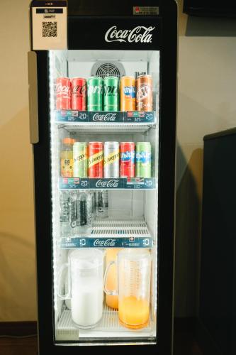 an open refrigerator filled with drinks and drinks at The Ten Hotel Thippanate in Chiang Mai