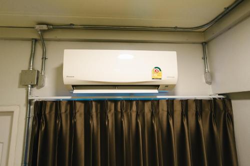 a printer is sitting on top of a curtain at The Ten Hotel Thippanate in Chiang Mai