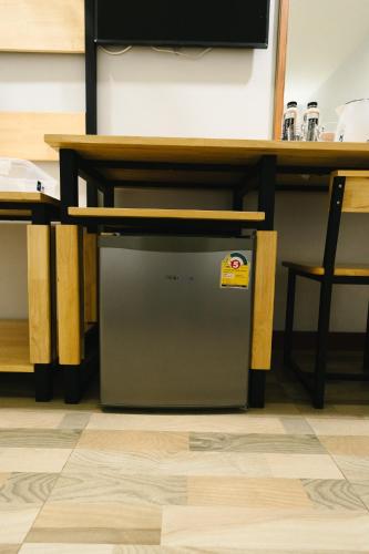 a small appliance sitting under a table on a floor at The Ten Hotel Thippanate in Chiang Mai