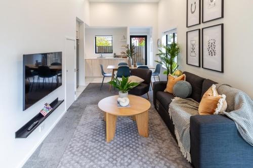 a living room with a couch and a table at Urban Comfort on Durham St, Walk Everywhere! in Christchurch