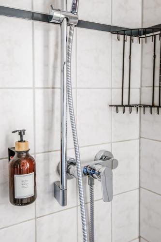 a shower with a bottle of soap in a bathroom at Hotel Gartenstadt Erfurt in Erfurt