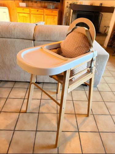 a chair with a table in a living room at Chalet Des Charmes in Thollon