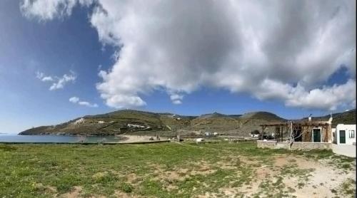 a house on the shore of a body of water at Simousi Beach House in Kithnos