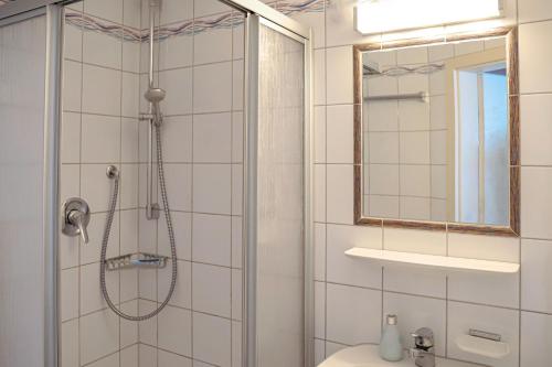 a bathroom with a shower and a sink at Hotel Garni Vitamari in Wasserburg am Bodensee