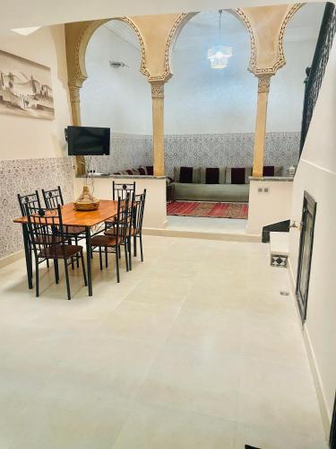 a dining room with a table and chairs at Riad Nour Resorts-Riad Nour Travel in Marrakech