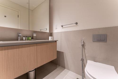a bathroom with a sink and a toilet at HAVN - 2 Bedroom in Bayshore, Dubai Creek Harbour in Dubai