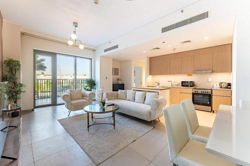 a living room with a couch and a table at HAVN - 2 Bedroom in Bayshore, Dubai Creek Harbour in Dubai