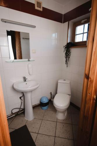 a bathroom with a toilet and a sink at Porto Resort in Lilaste