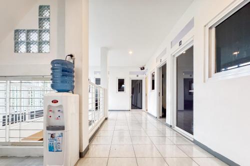 a hallway of a house with a water heater at Urbanview Syariah Sentul City Bogor in Cibitung