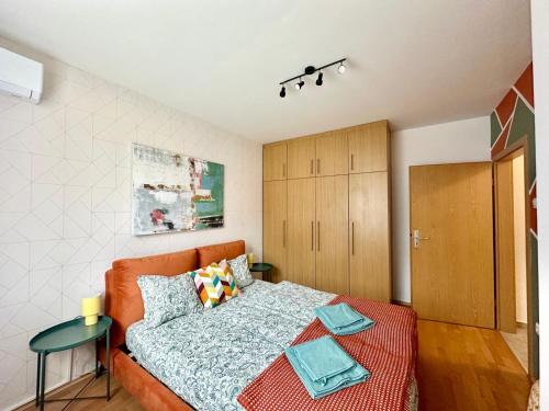 a bedroom with a bed and a wooden cabinet at Akácfa Apartment by Chivi II FreeParking in Budapest