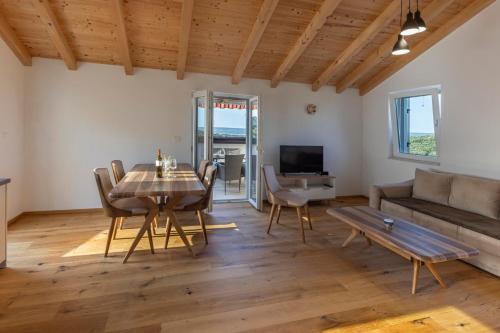a living room with a table and a couch at Apartments with parking space Sveti Jakov, Losinj - 24153 in Mali Lošinj