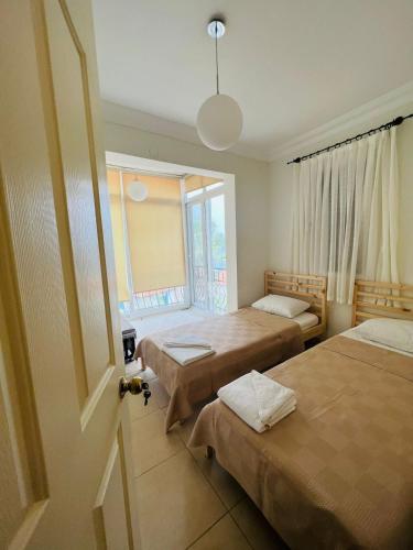 a room with two beds and a window at Monix Homes-Villa Magic Garden in Kaş