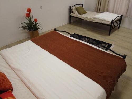 a large bed in a room with a couch at Luban Camping House in Bidiyah