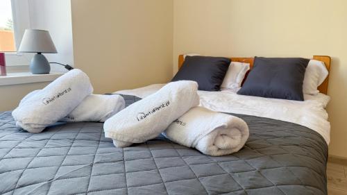 two beds with towels and pillows on them at Na Mijance by LibertaRent in Wałbrzych