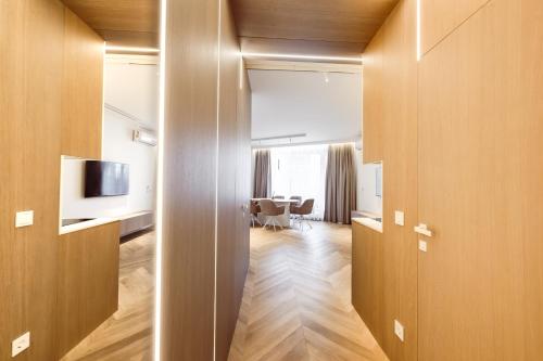 a living room with a television and a dining room at Golden Dunes Apartment in Palanga