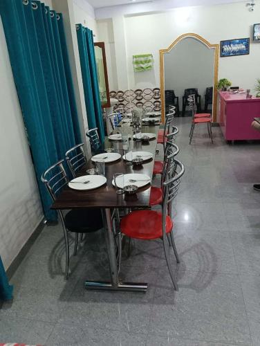 a dining room with a long table and chairs at Devlok Tourist Complex in Barkot