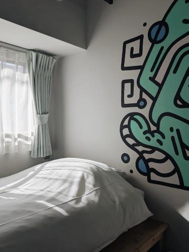 a bedroom with a white bed and a window at ART HOTELS SHIBUYA in Tokyo