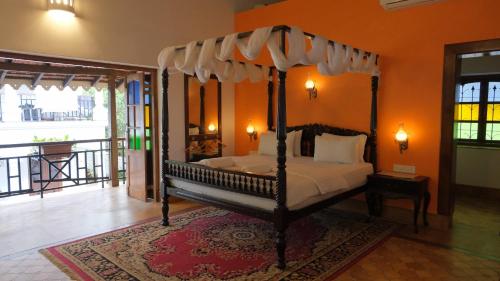 a bedroom with a canopy bed in a room at Casa Memora 3BHK Private Pool Villa in Saligao