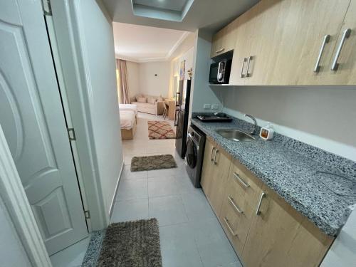 a small kitchen with a sink and a stove at Scanddic Resort Hurghada in Hurghada