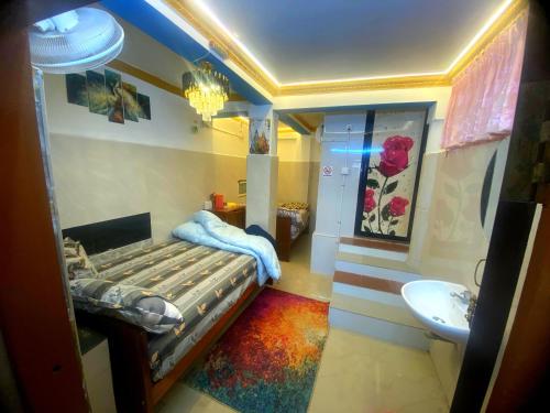 a bedroom with a bed and a sink and a toilet at Avatar Sea Beach Homestay in Malpe