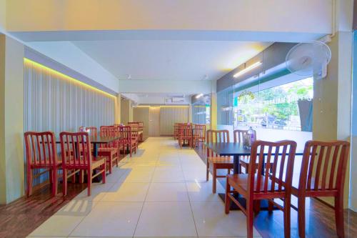 a dining room with tables and chairs in a restaurant at Treebo Park Palace in Guwahati