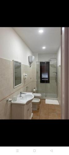 a bathroom with a sink and a toilet and a shower at Da Peppino e Nicchella in Marina di Camerota