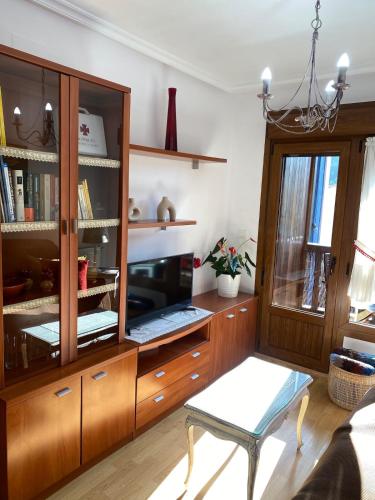 a living room with a large wooden cabinet at Balcón del atardecer in Cangas de Onís