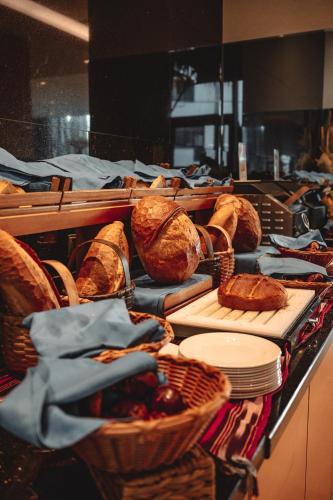 a counter with baskets of bread and baskets of food at Servi House - Trabzon in Trabzon