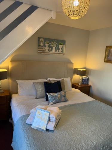 a bedroom with a bed with two pillows at Broadlands in Bourton on the Water