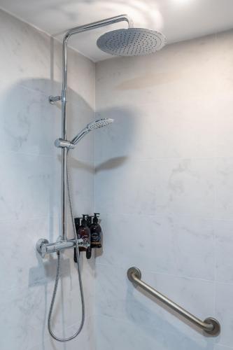 a shower in a bathroom with a shower head at Casa de Amancio in Lavacolla