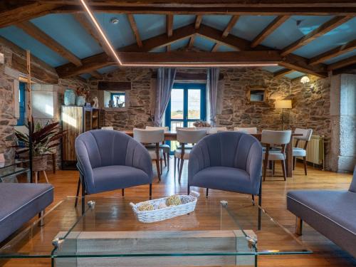 a living room with a table and chairs at Casa de Amancio in Lavacolla